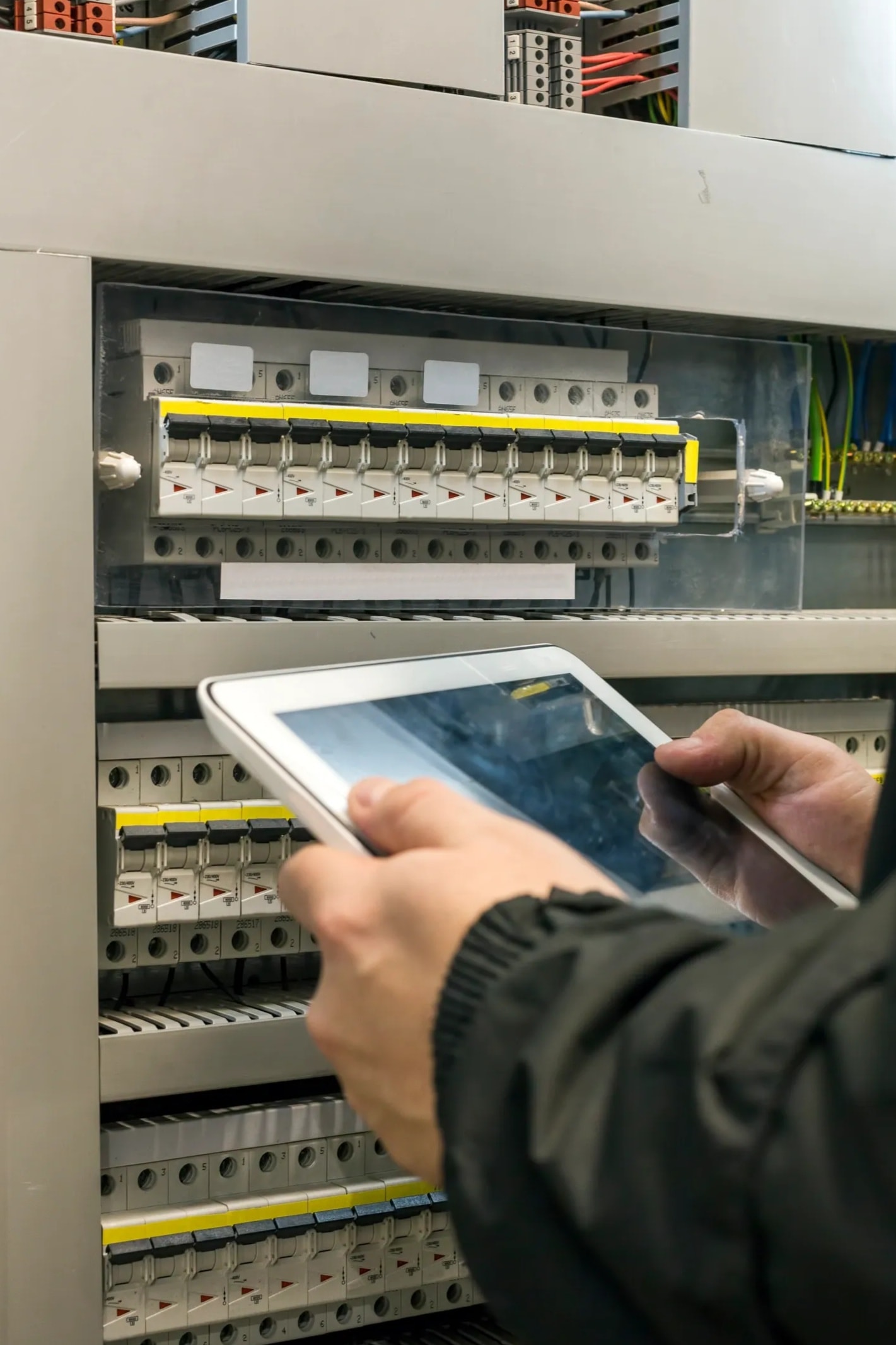 Electrical technician working on automation control panel